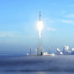 a rocket launching into the sky with smoke billowing from it