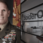 a man in military uniform standing next to flags