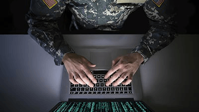 a man in uniform using a laptop computer