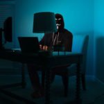 a man sitting in front of a laptop computer