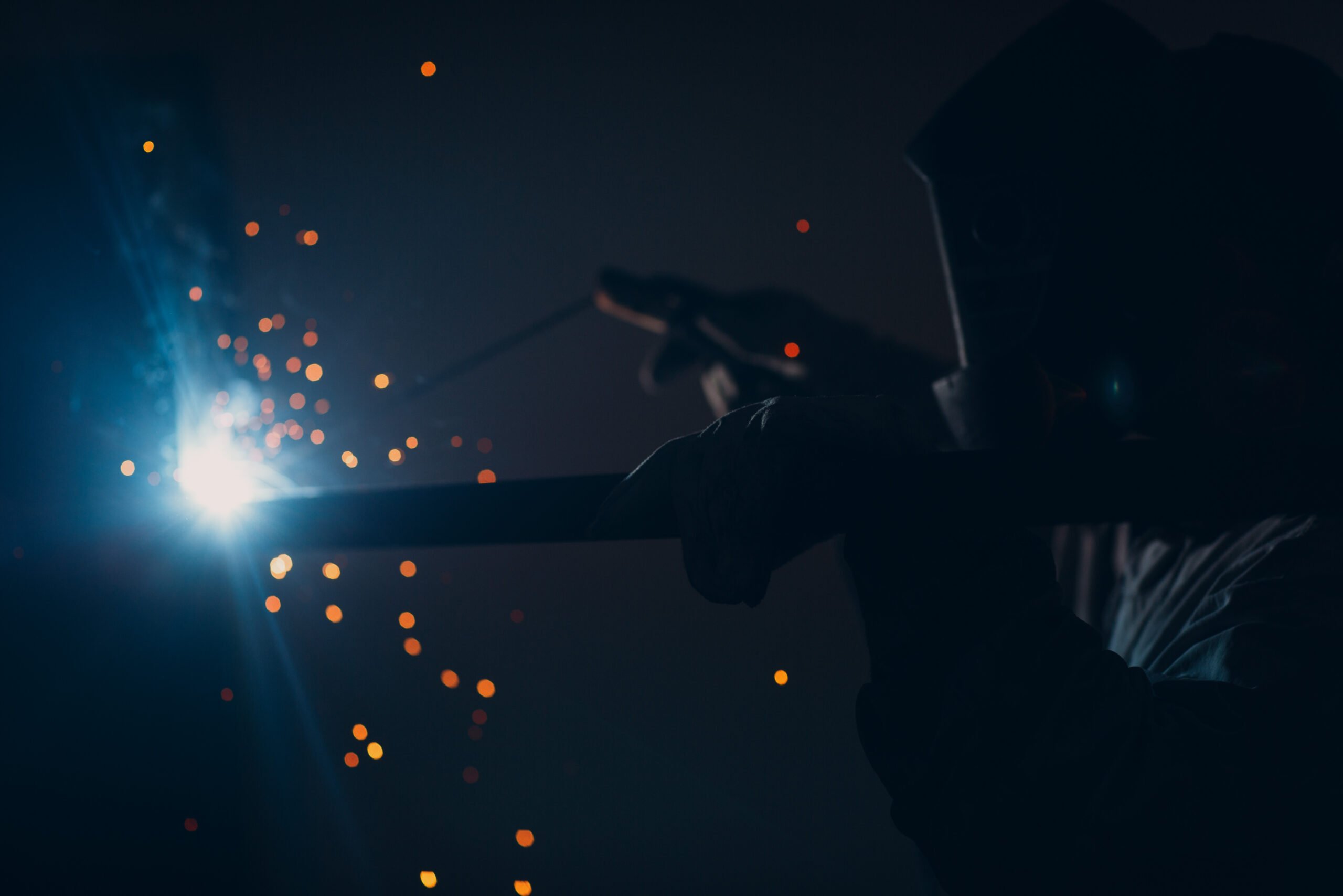 a person holding a metal object in the dark